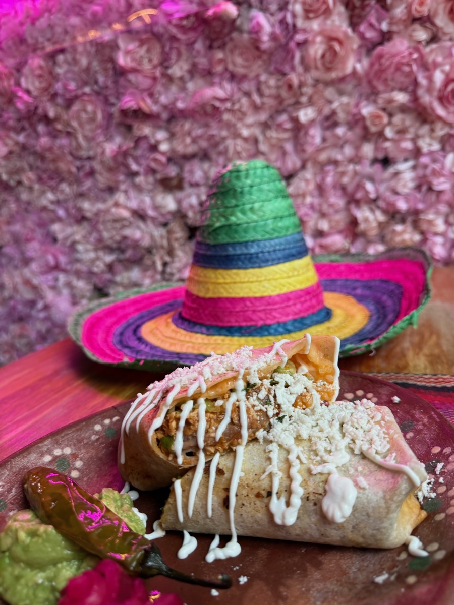 Burrito Birria stuffed with beef birria, rice and beans, with a side of birria broth