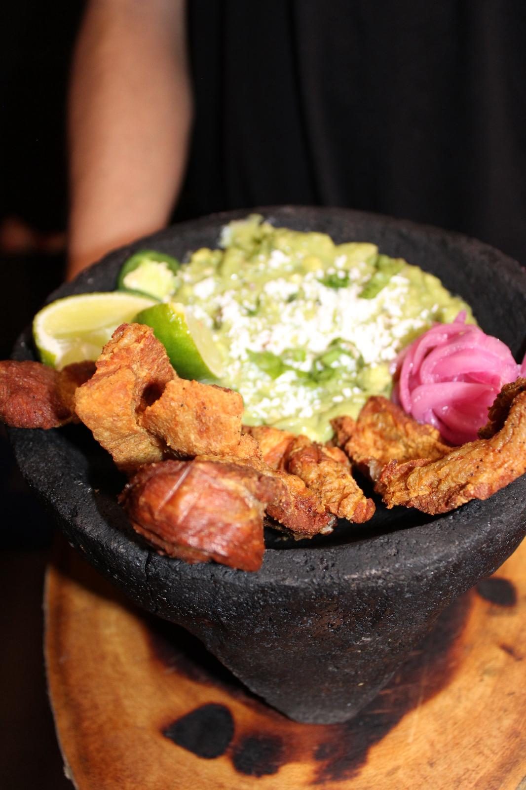 Guacamole with crispy chicharrón and corn tortillas