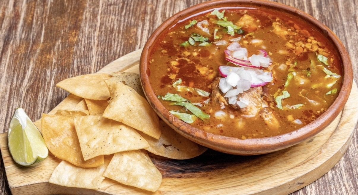 Pozole traditional red pork soup with tostadas